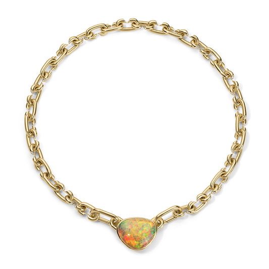 Gold chain necklace with a heart-shaped opal stone on a white background