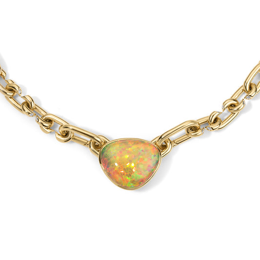Gold chain necklace with a heart-shaped opal pendant on a white background