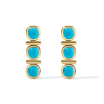 Pair of gold earrings with turquoise stones on a white background