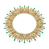 Gold necklace with emerald stones on a white background