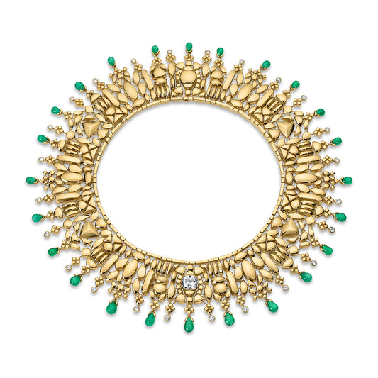 Gold necklace with emerald stones on a white background