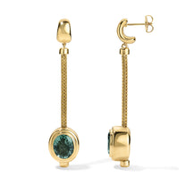 Gold earrings with green gemstones on a white background